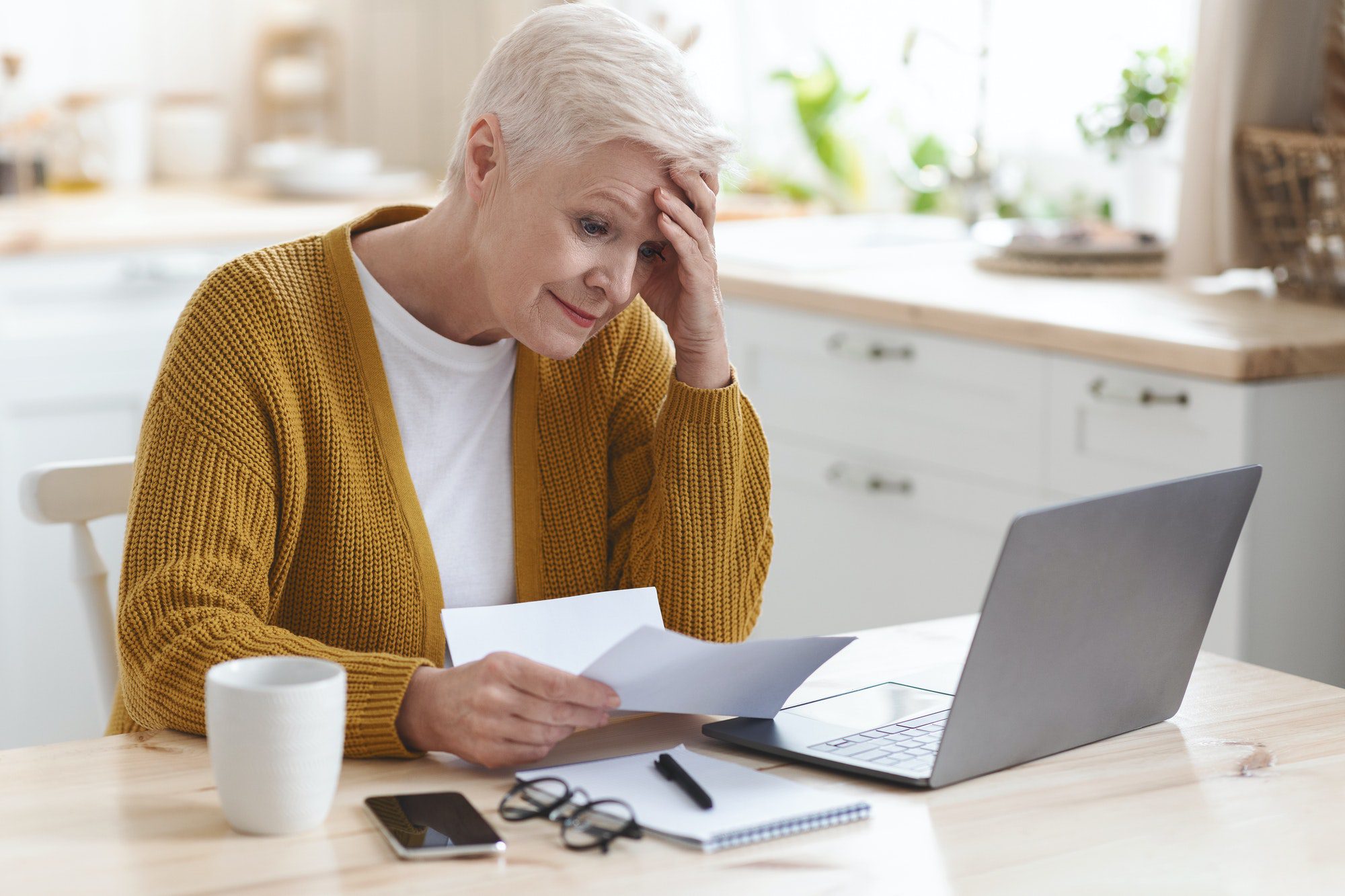 Upset senior studying possible mistakes that can be made in medicare.